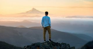 person standing on top of mountain