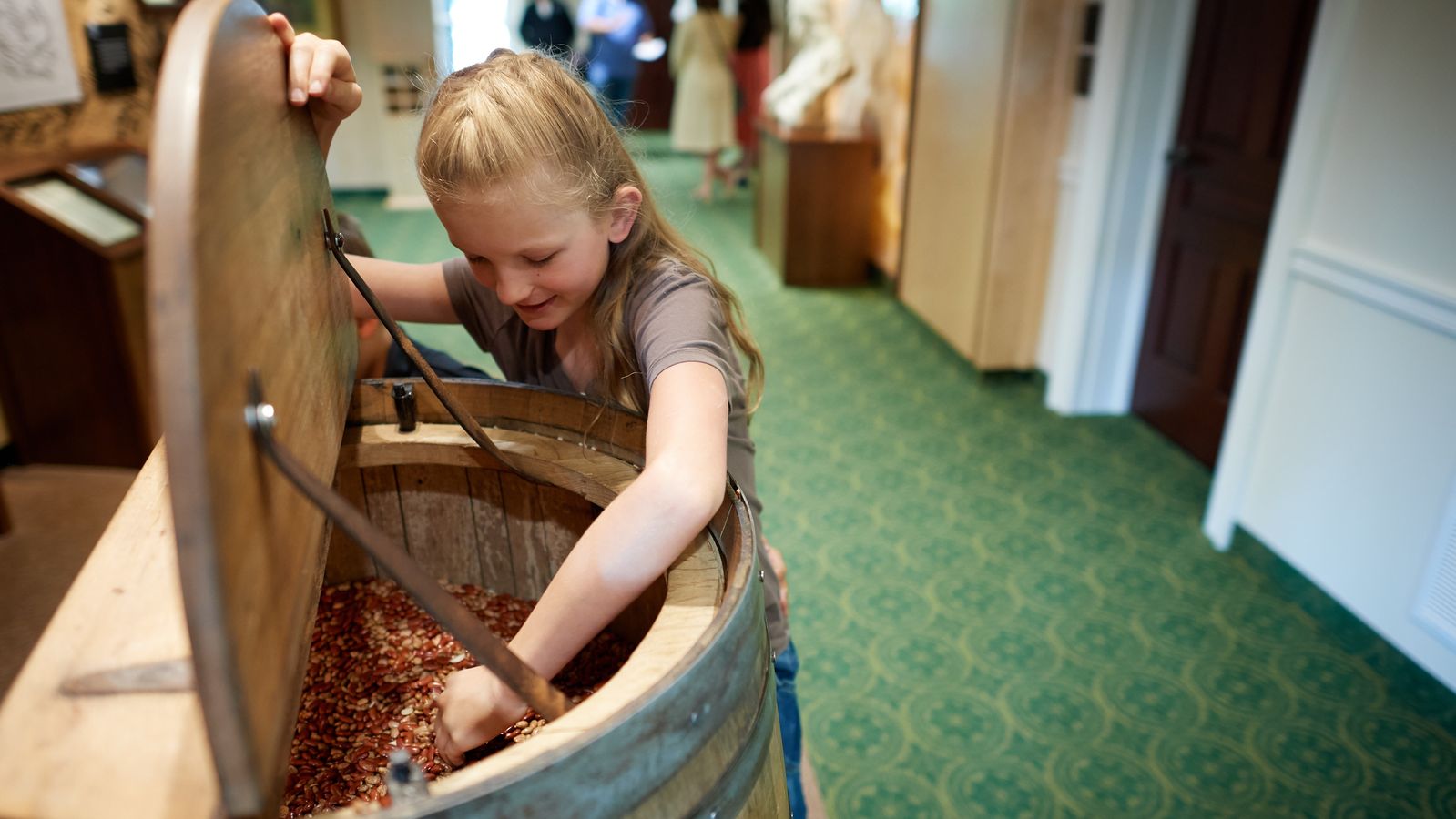 Various people interact with exhibits in Historic Sites found in New York and Pennsylvania. They appear to be in a Visitors' Center.