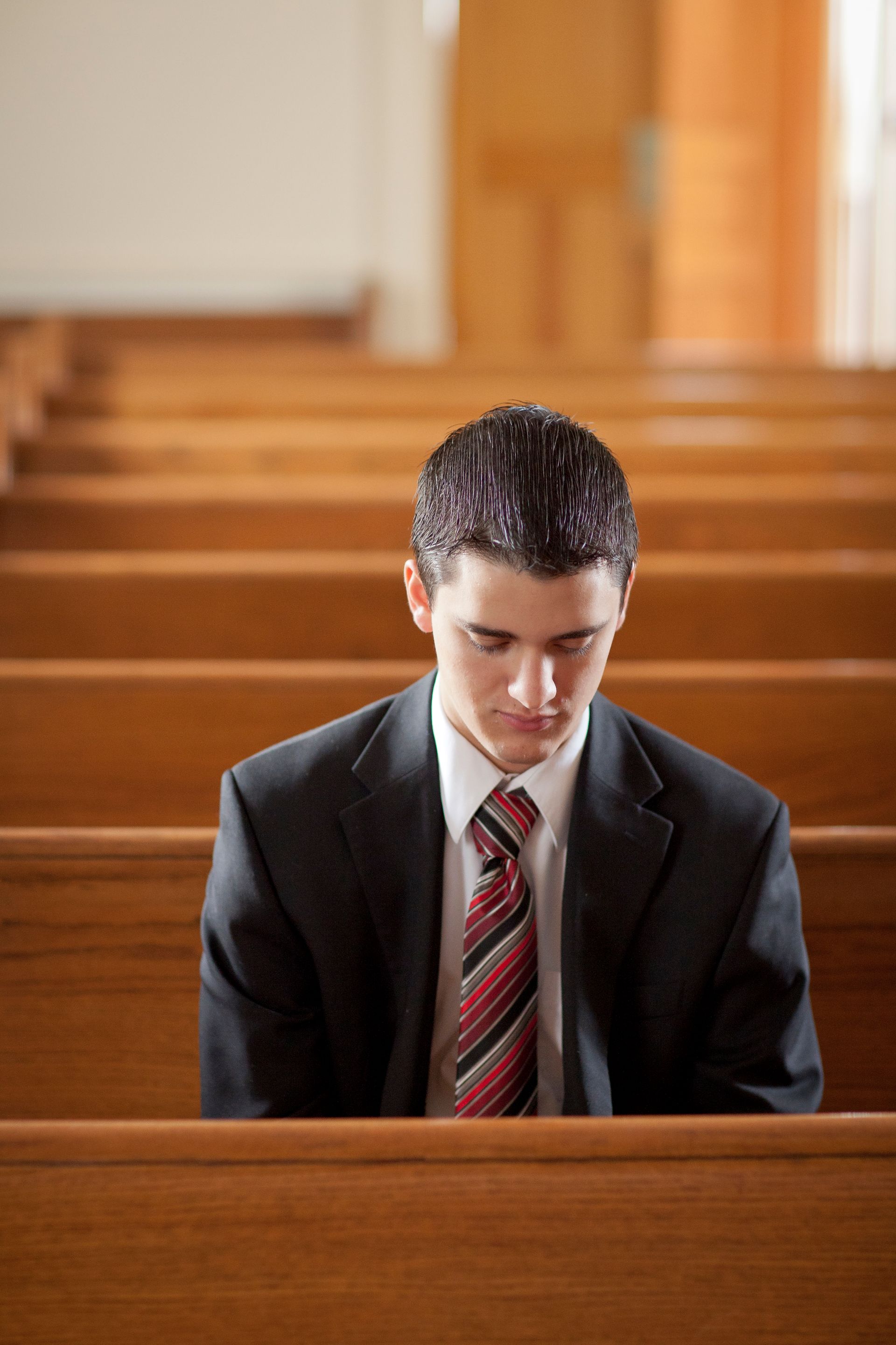 A young man prays in the chapel.