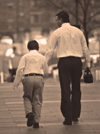 boy and father walking away