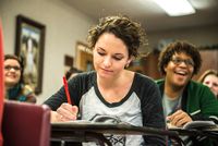 student writing in a journal