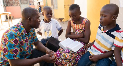 father and children reading