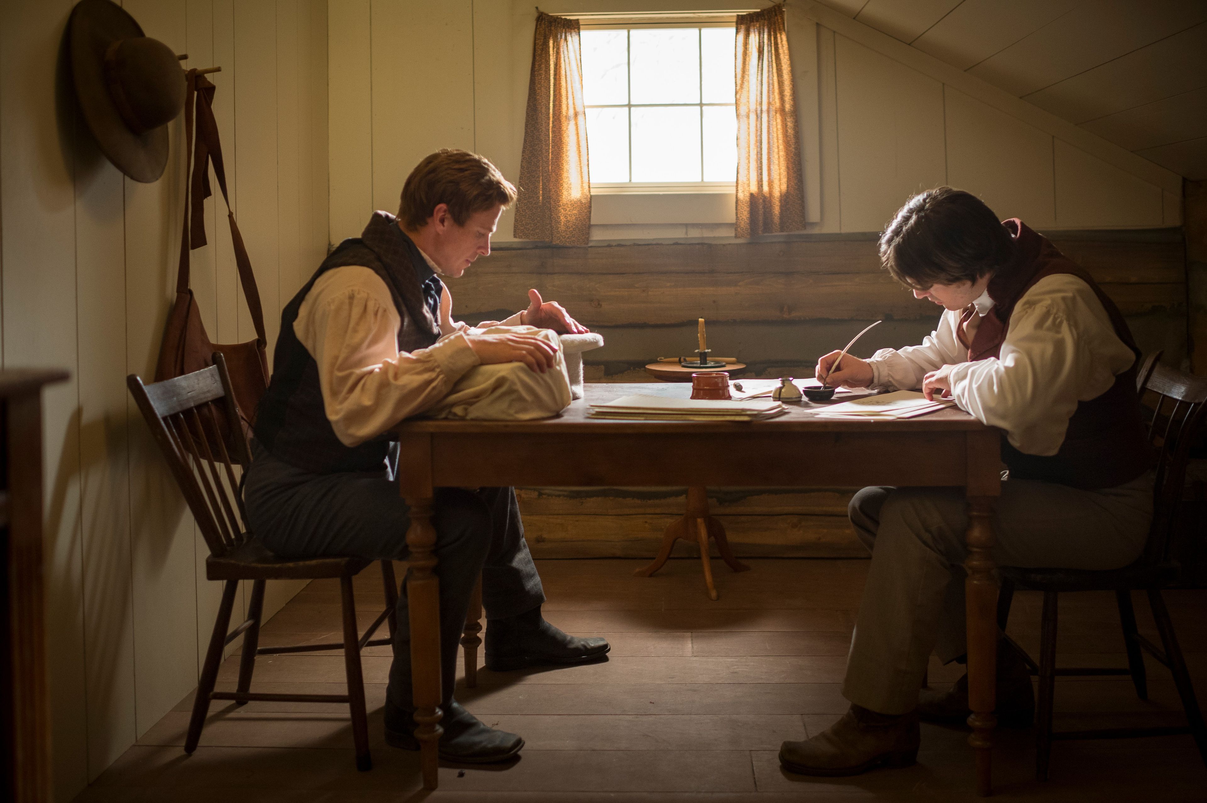 An image from the video “A Day for the Eternities” depicting Joseph Smith translating the Book of Mormon, dictating the text to his scribe, Oliver Cowdery.