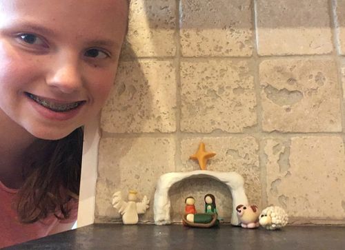 Megan Beck smiles as she shows off her nativity set.