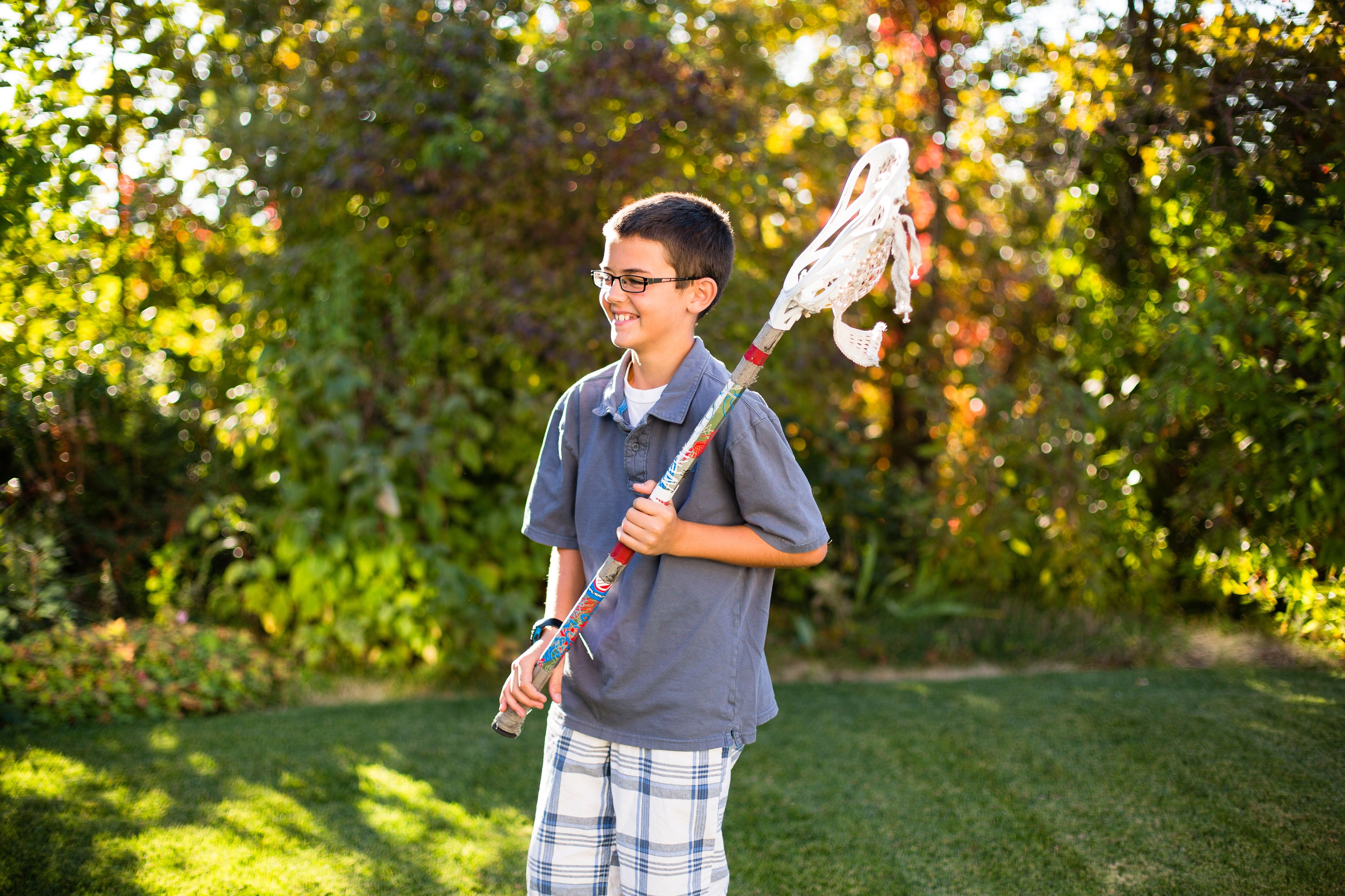 A boy plays lacrosse.