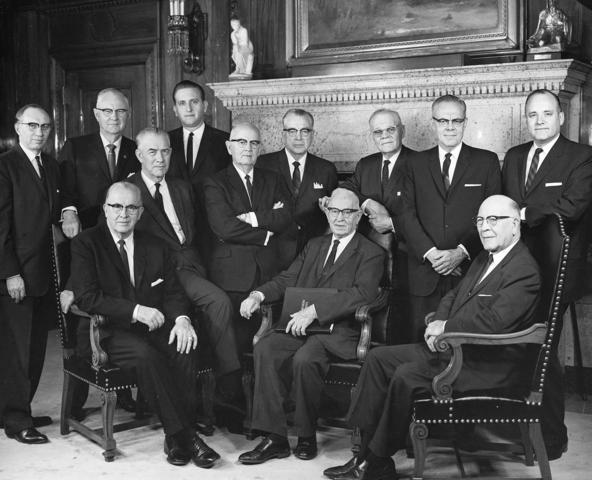 The Quorum of the Twelve Apostles in 1965. Seated left to right: Ezra Taft Benson, Mark E. Petersen, Joseph Fielding Smith, LeGrand Richards. Standing left to right: Gordon B. Hinckley, Delbert L. Stapley, Thomas S. Monson, Spencer W. Kimball, Harold B. Lee, Marion G. Romney, Richard L. Evans, and Howard W. Hunter.