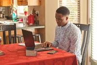 youth typing on computer