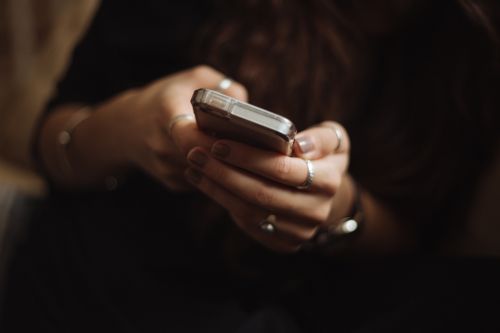 woman holding cell phone