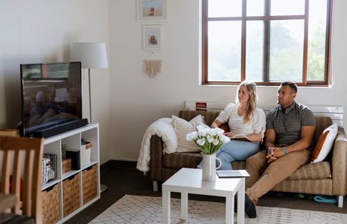 couple watching conference together in their home