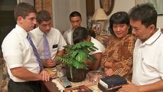 elders and family kneeling