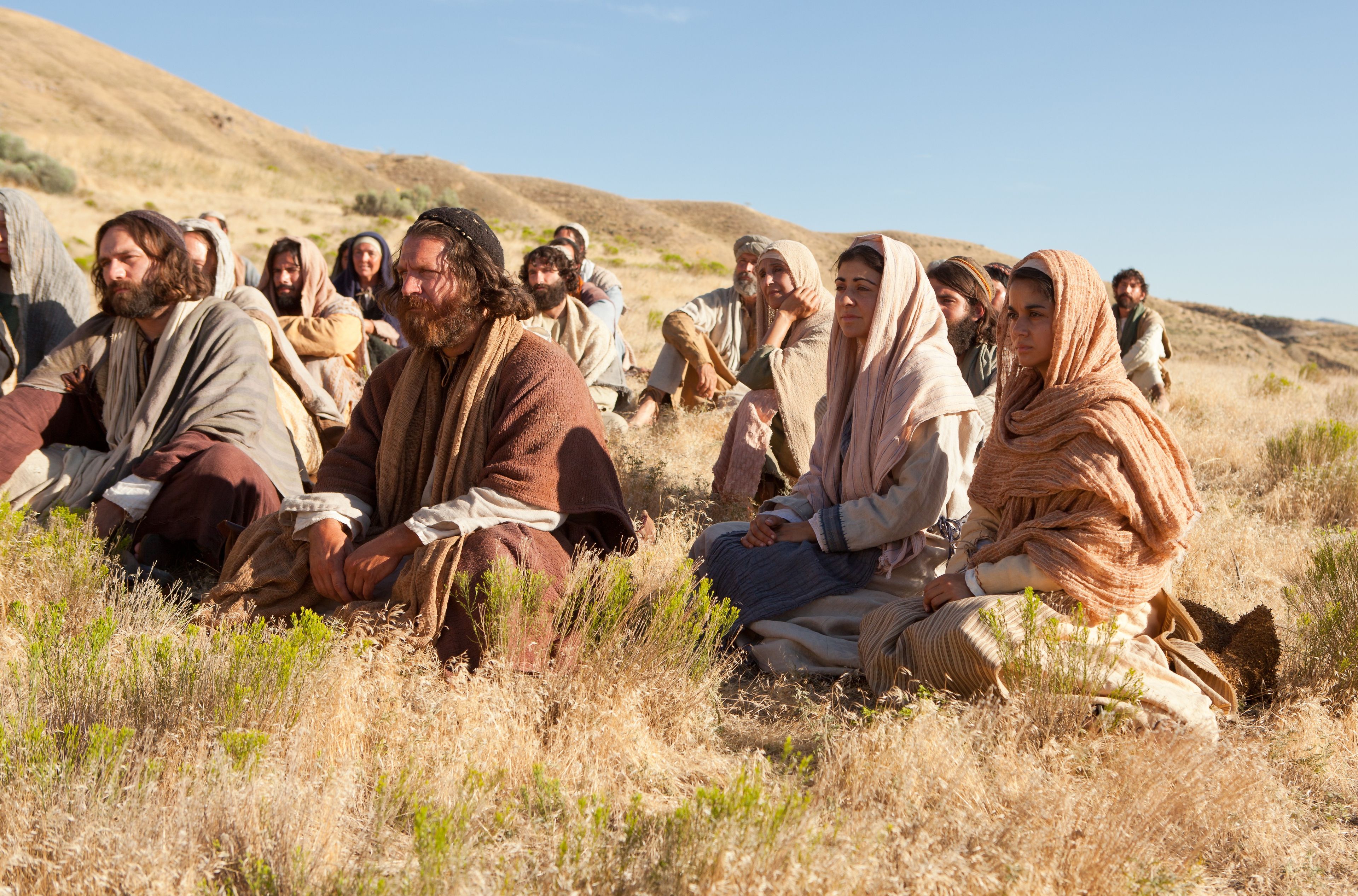 Listeners sit around Jesus as He teaches of the higher law.