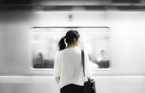 young adult standing by train