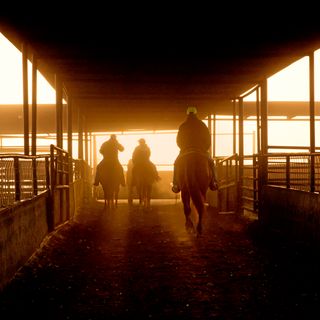 men on horses at ranch pens