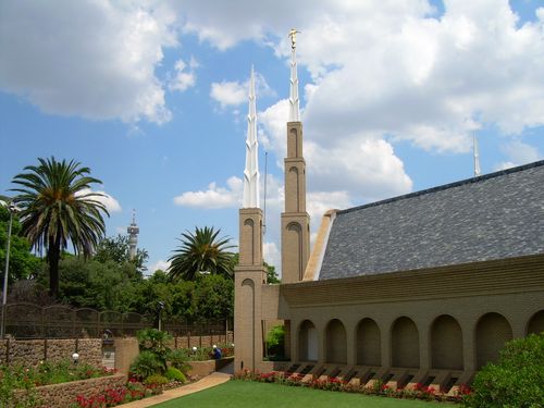 Several spires on the Johannesburg South Africa Temple, with local trees and other vegetation on the left side.