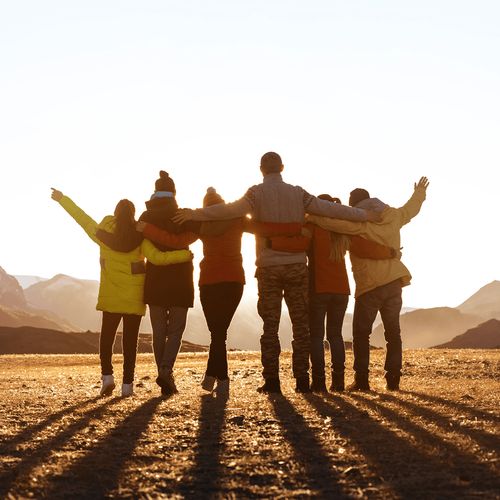 a line of people with arms arounds each other’s shoulders