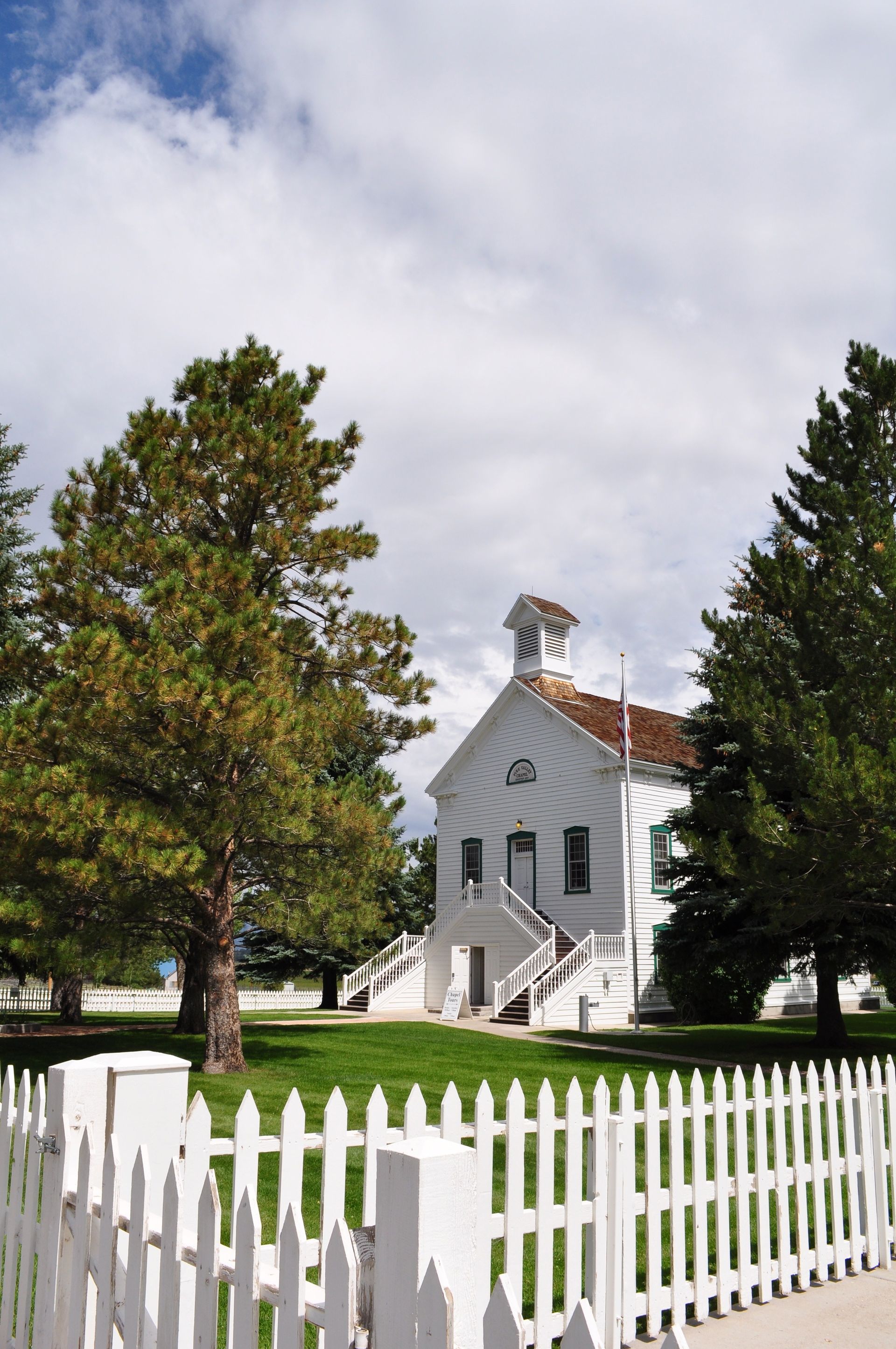 A white fence bordering a historic Pine Valley chapel in Utah.