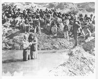 Native Americans being baptized