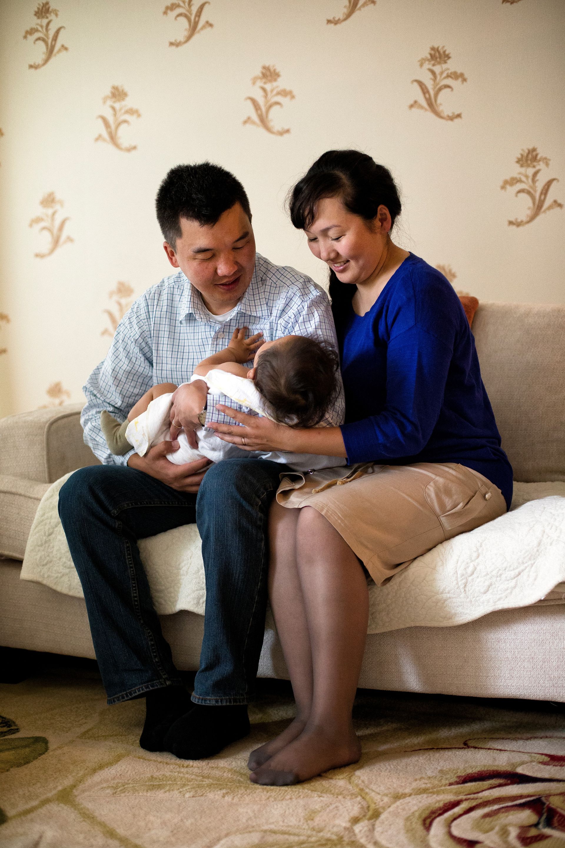 A mother and father in Mongolia hold their baby.  