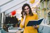 Woman reading a book and talking on the phone