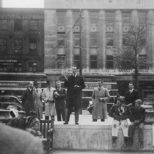 M. Russell Ballard preaching in a market square