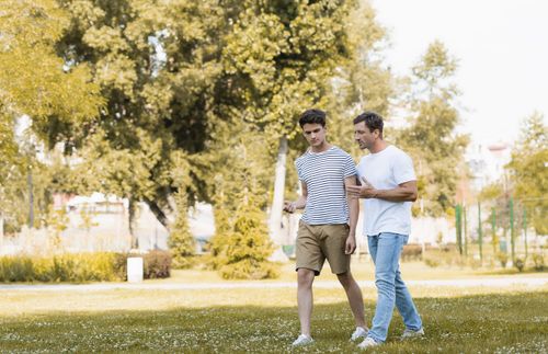 father and son walking and talking together