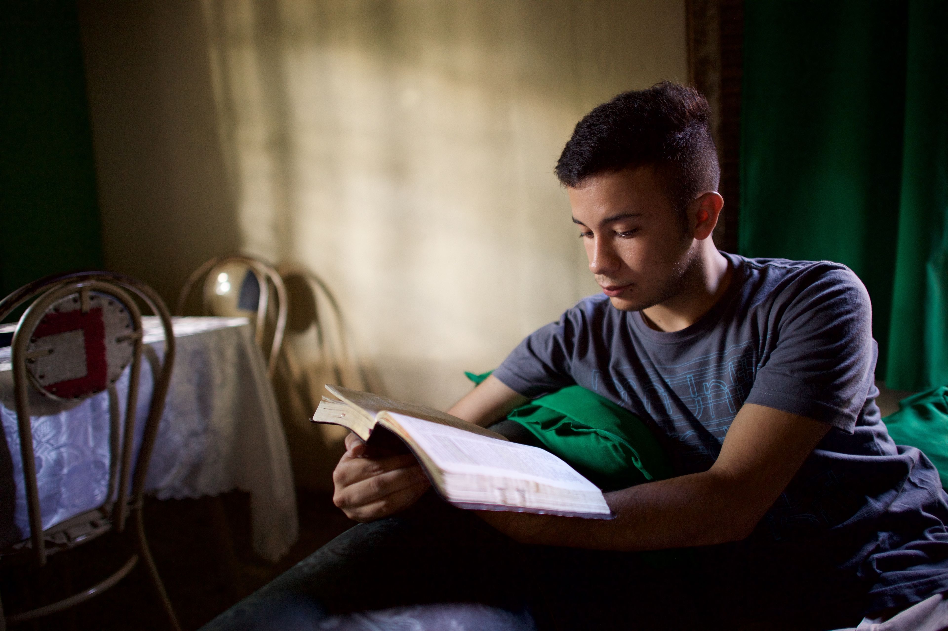 A young man studying scriptures.