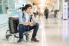 Man sitting with luggage in airport