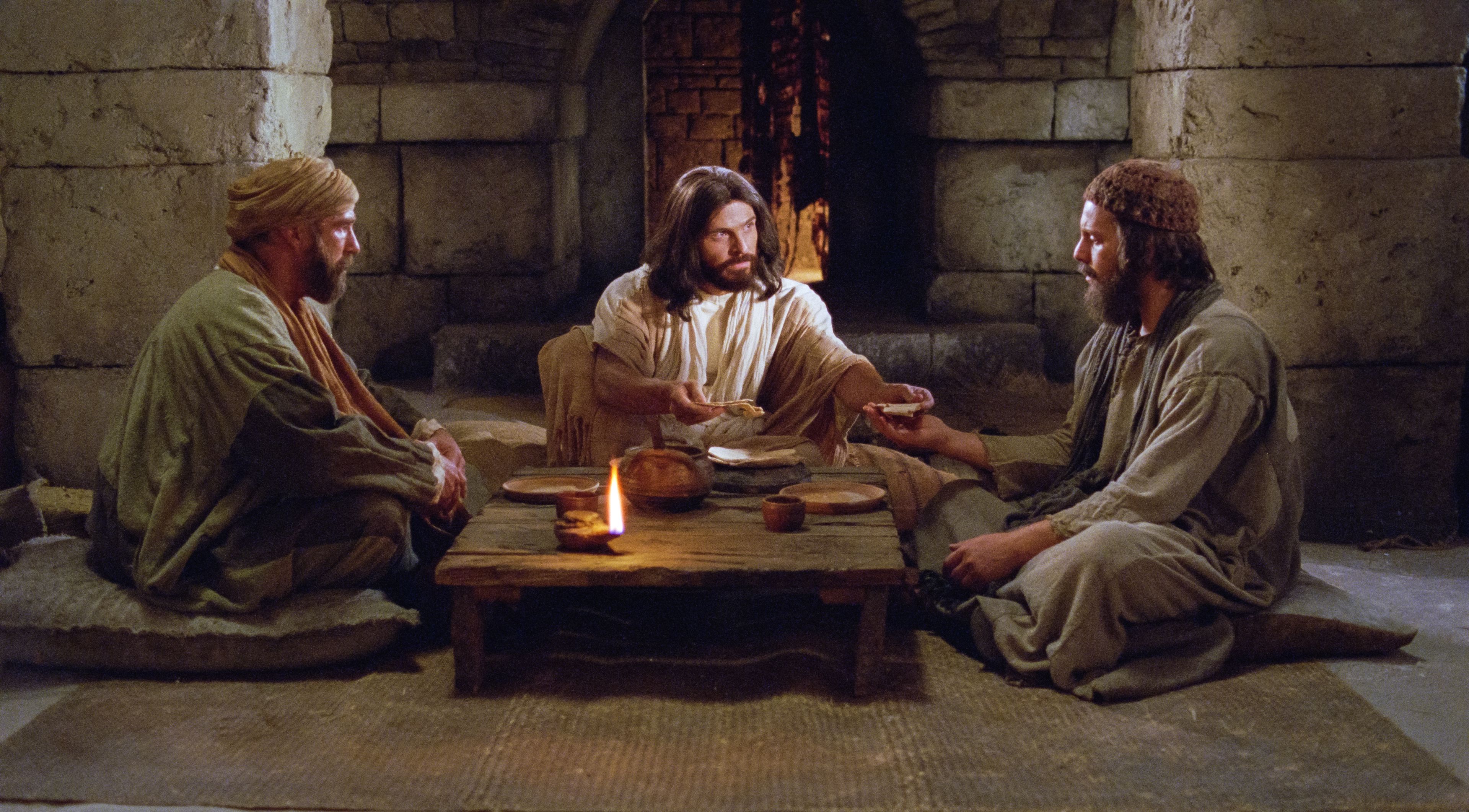 Christ communes with two disciples after having met them on the road to Emmaus.