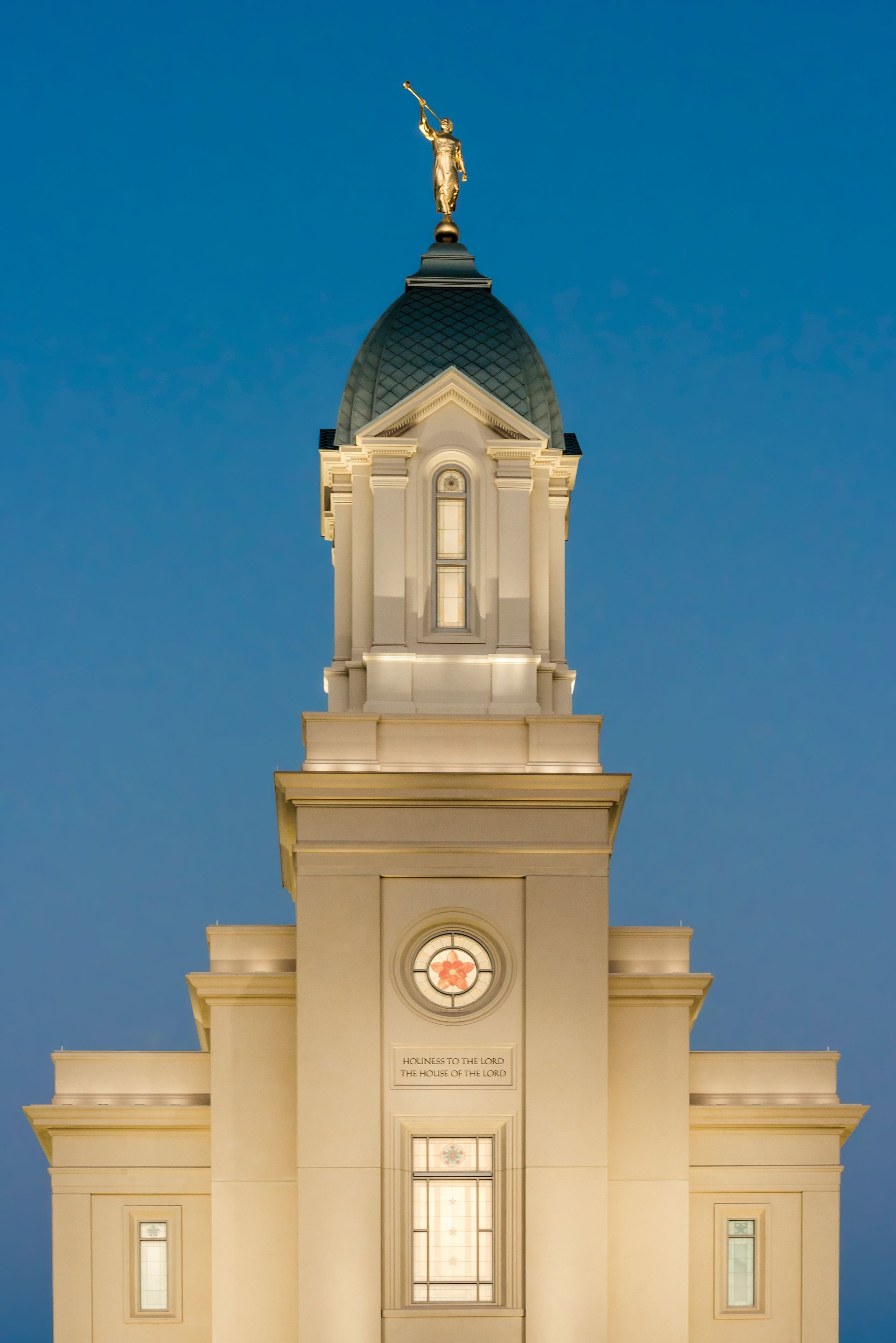 A photograph of the Cedar City Utah Temple steeple in the late evening.