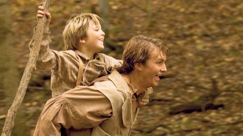 Scene from "Joseph Smith: Prophet of the Restoration". Actors portraying the Smith Family enact a scene where Alvin carries Joseph down a road. Joseph is carrying a cane/staff.