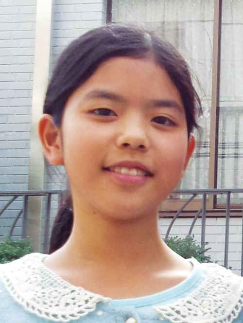 young woman and leader in front of a building. Nodoka T.