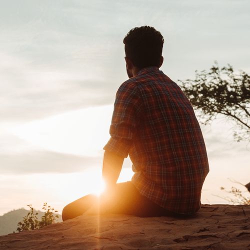 young man watching sunset