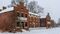 Exterior of red brick buildings covered in snow.