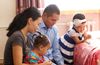 family kneeling in prayer