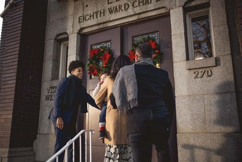 People entering the front doors of a church