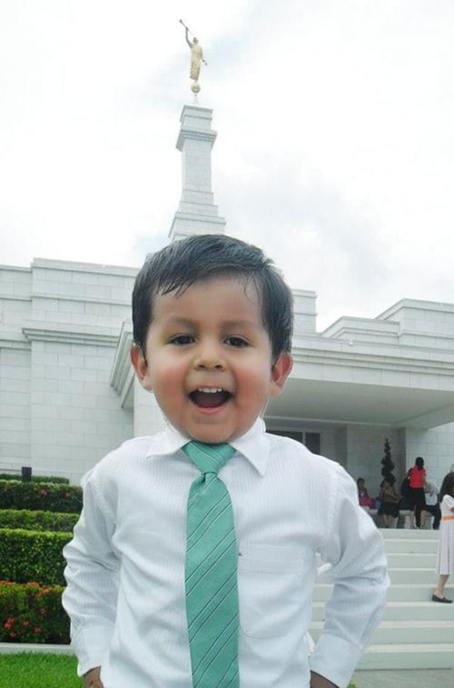 boy standing outside temple in Mexico