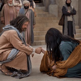 Jesus Christ helping kneeling woman