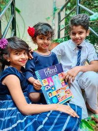 children holding copy of the Friend magazine