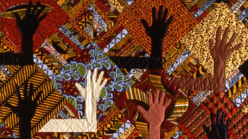 quilt showing hands of many skin colors