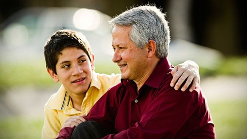 young man talking to father