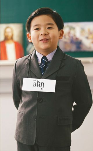 young boy wearing the name Nephi around his neck