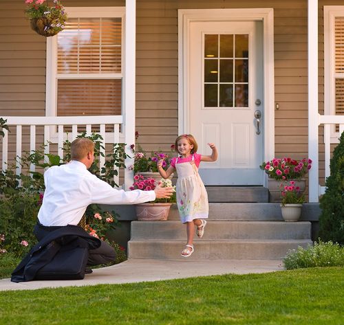 daughter welcoming father home from work