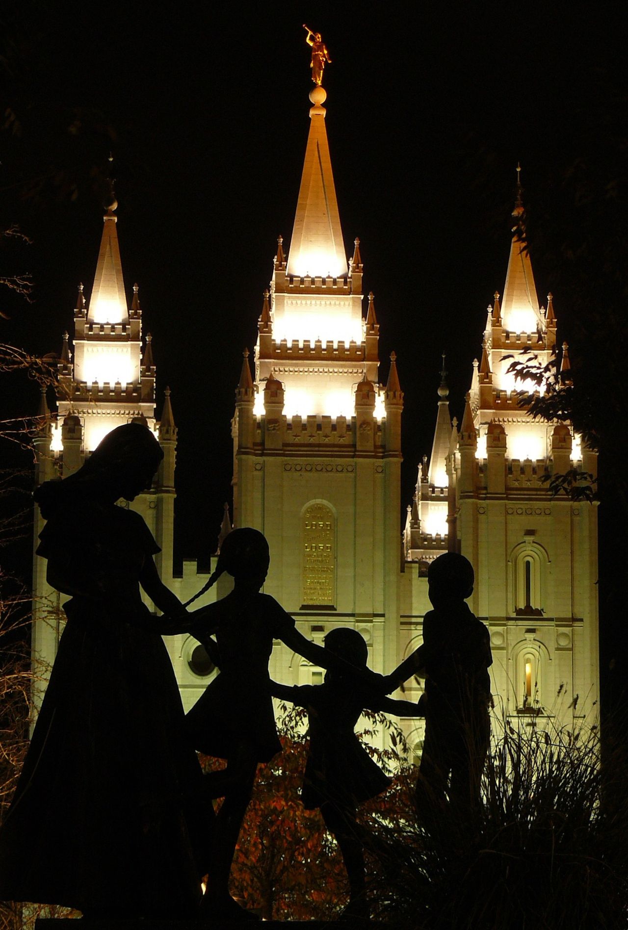 The Salt Lake Temple in the evening, including the statue and scenery.