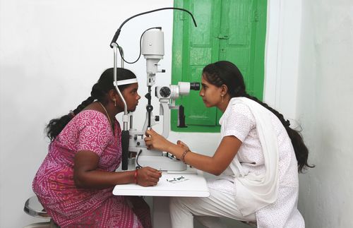 eye doctor examining a woman’s eyes