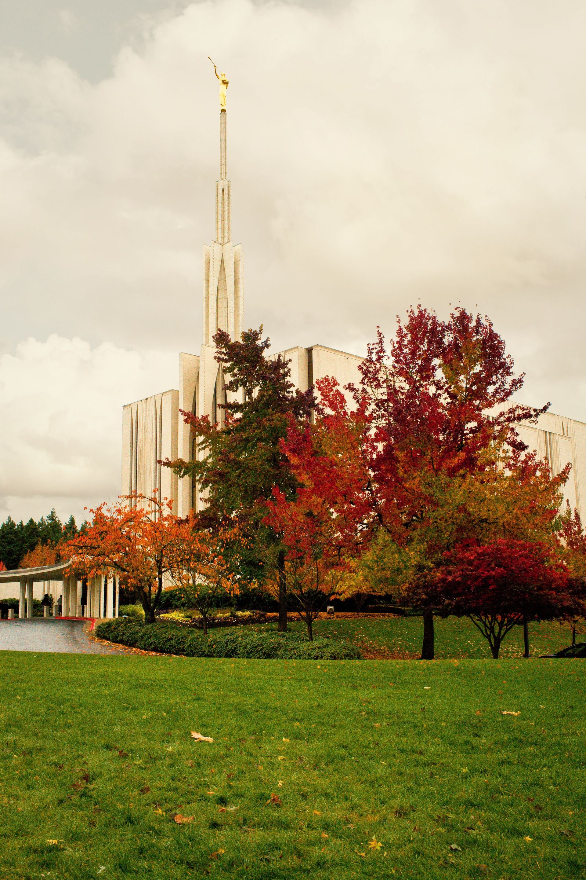 A side view of the Seattle Washington Temple in the fall, including the spire and scenery.