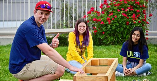 youth and leader building benches