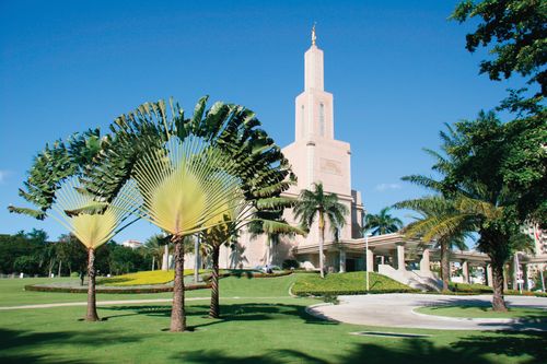 A partial view of the Santo Domingo Dominican Republic Temple, with the surrounding grounds covered in different types of trees.