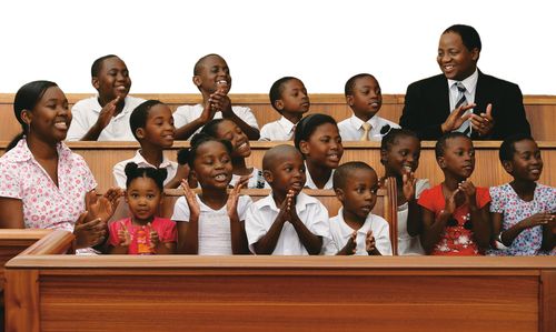 Primary children and teachers sitting together as a group in the chapel.