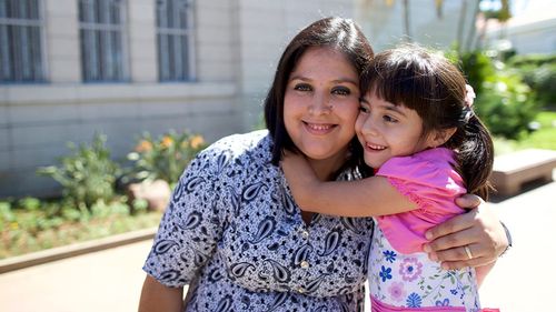 woman and young girl outside a temple