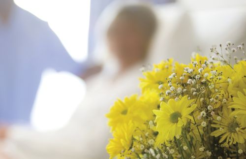 flowers and people in hospital room